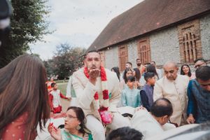 Guests gather outside a historic brick building during a cultural celebration.