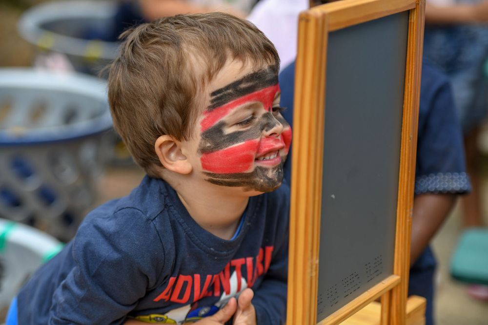 A candid photo of a small boy playing at a nursery school