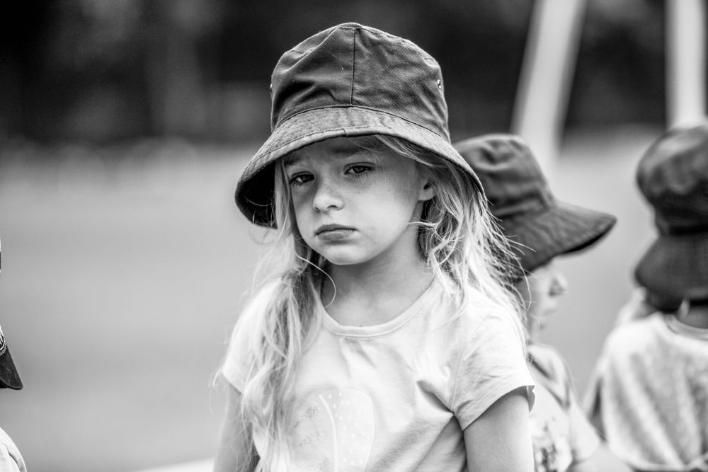 Candid shot of a pensive young girl at a school photo shoot