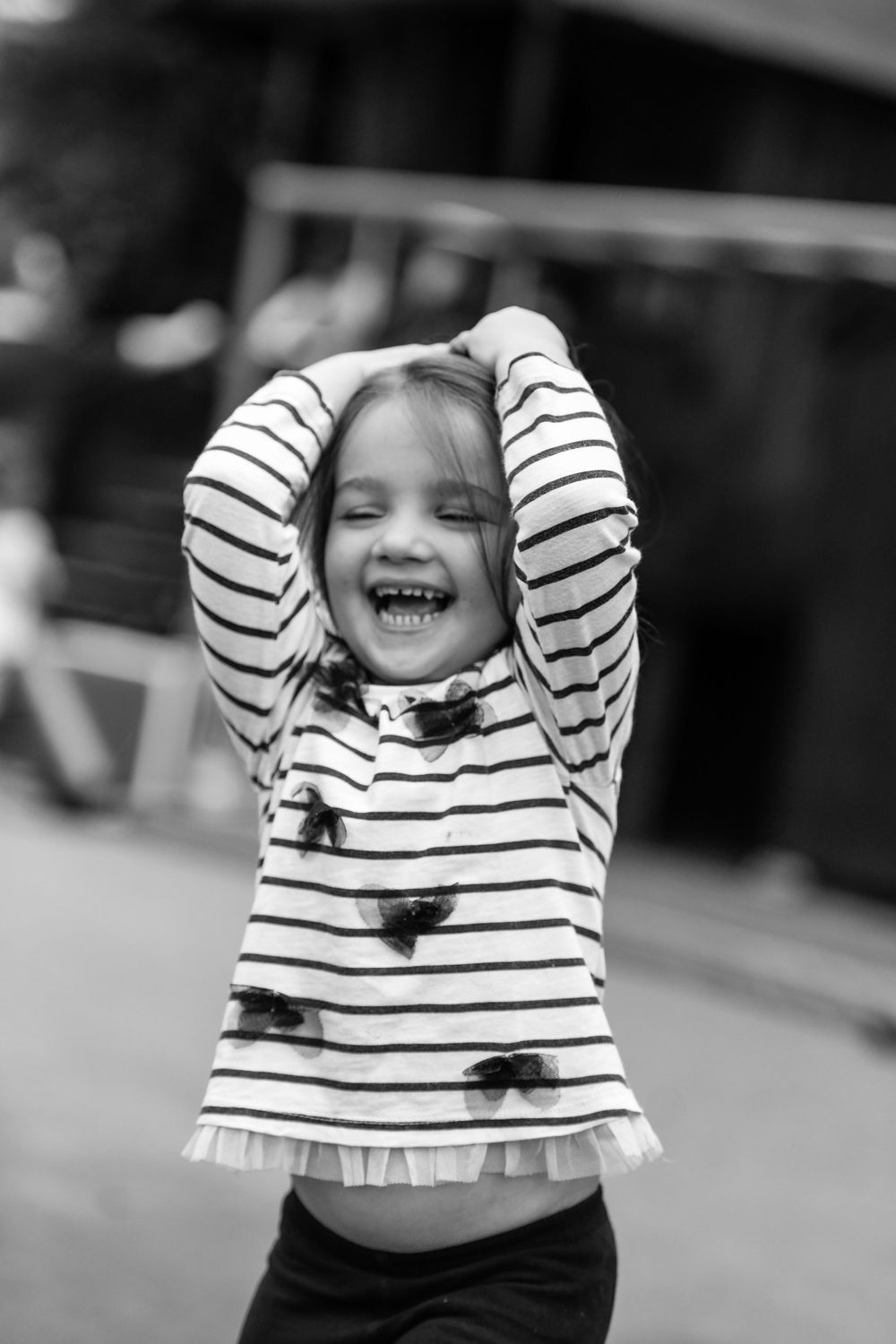 A child laughing at a Nursery School photo shoot at St John's Bridge Nursery School