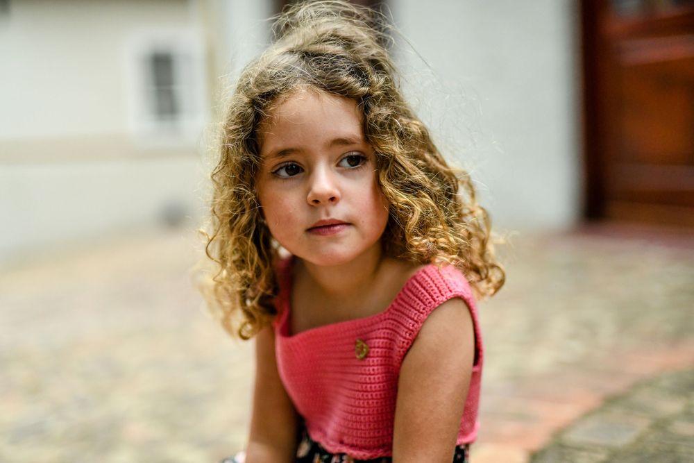 A photo of a child posing for a photo shoot at a pre-school
