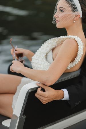 Newly weds exiting on the back of a boat on Lake Austin at the Lake Austin Resort and Spa