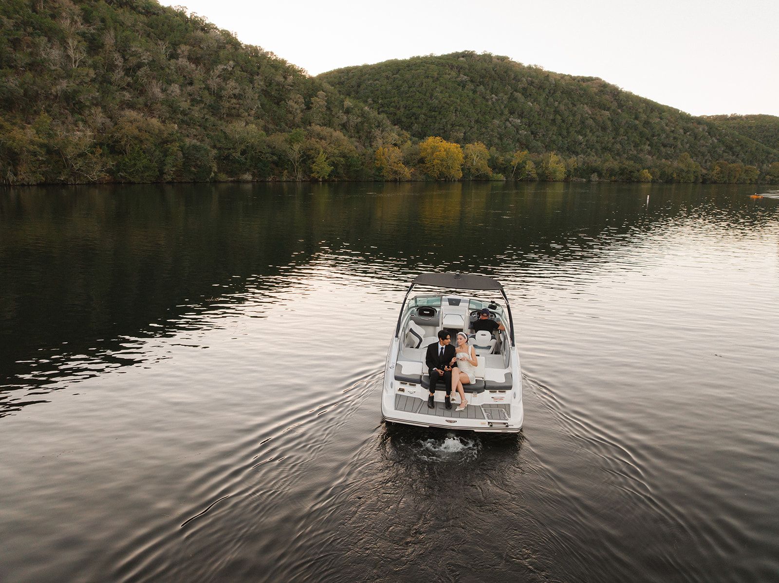 Newly weds exiting on the back of a boat on Lake Austin at the Lake Austin Resort and Spa
