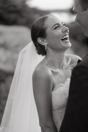 A candid moment of joy captured in black and white during a wedding celebration at the Dallas Arboretum's a Tasteful Place