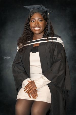 A graduation photo series showing a woman in black cap and gown against a dark background with elegant poses.