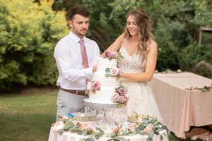 Wedding guests watching and celebrating during an outdoor reception.