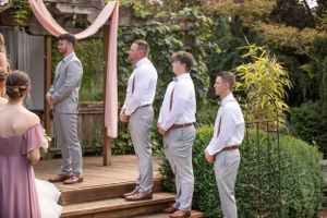 Groomsman at wedding in suspender's and slacks.