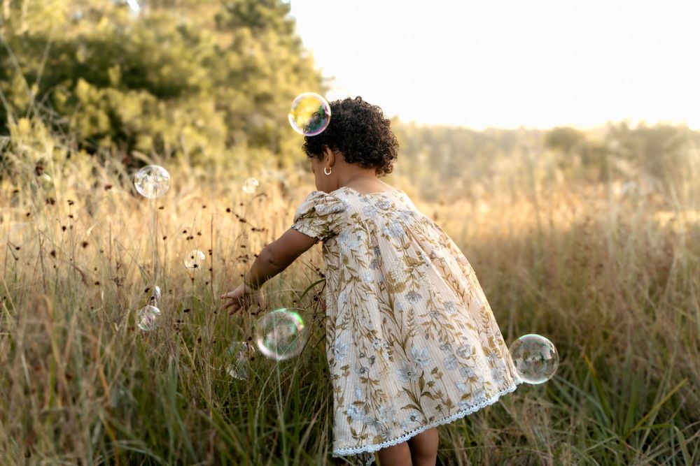 little girl playing in field