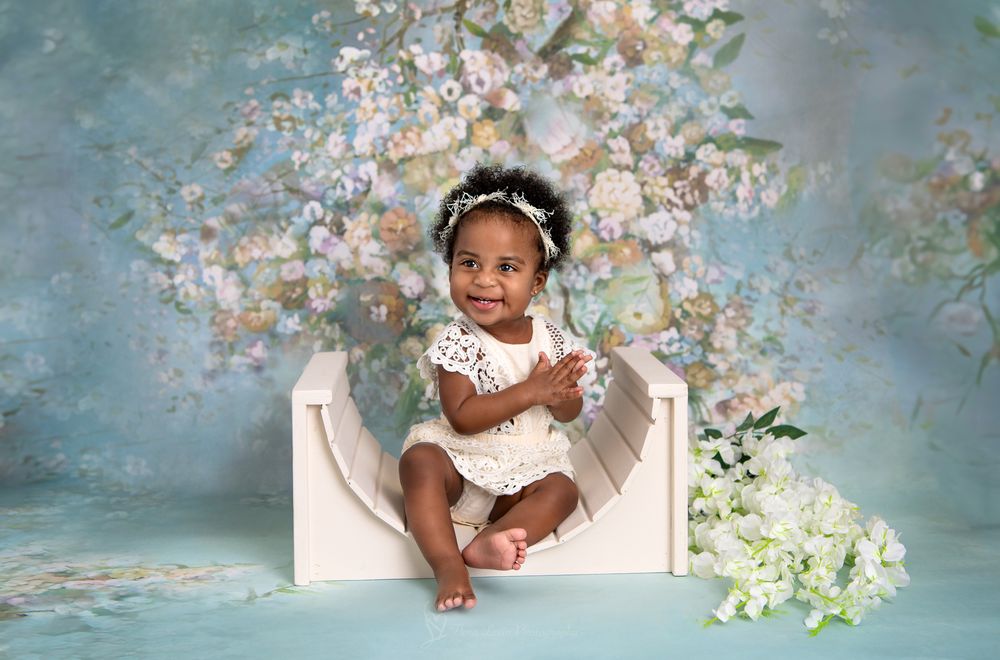 A professional studio portrait sequence with spring cherry blossoms against a blue-gray backdrop.