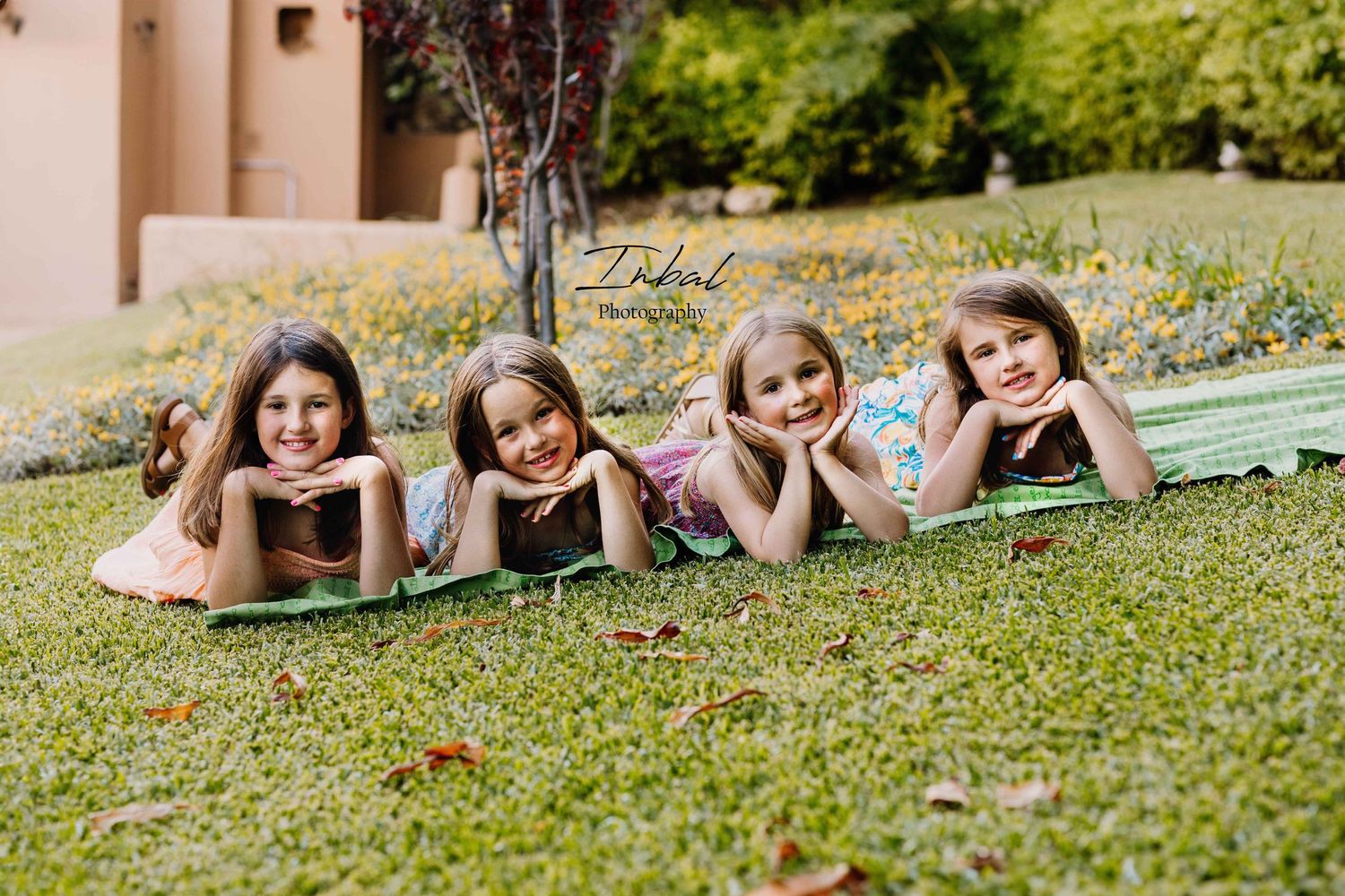 Four nephews lying down on the grass for a photo in Marbella.