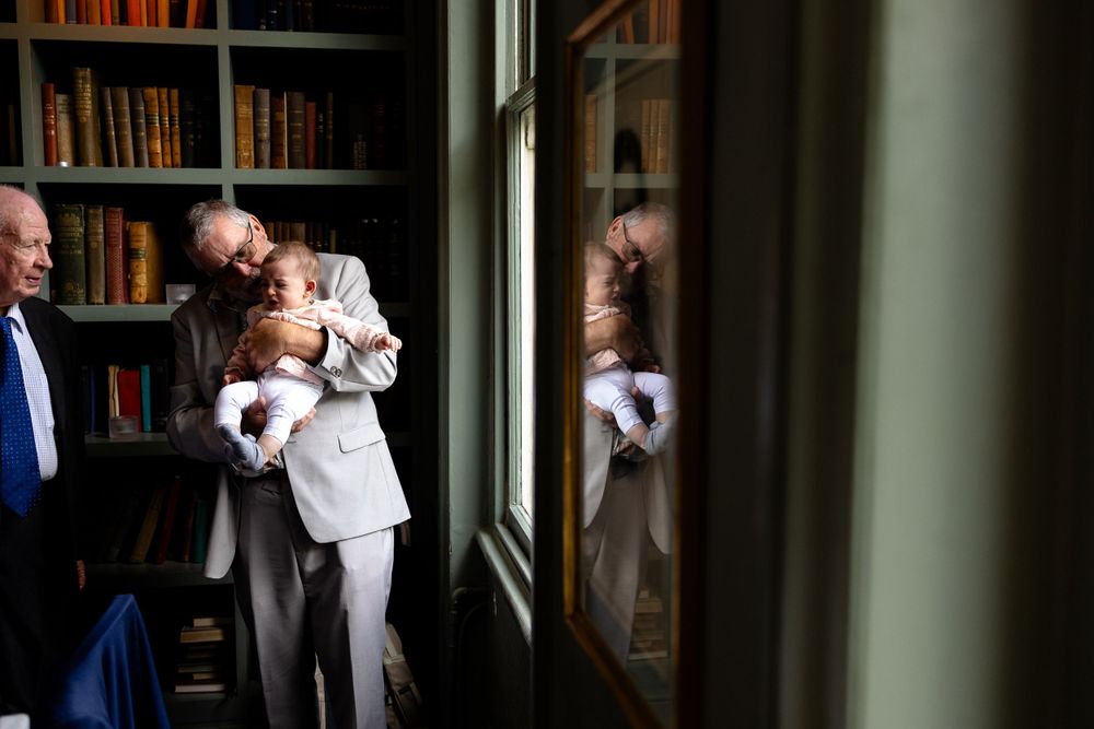 Group gathered by window in library sharing joyful moment together.