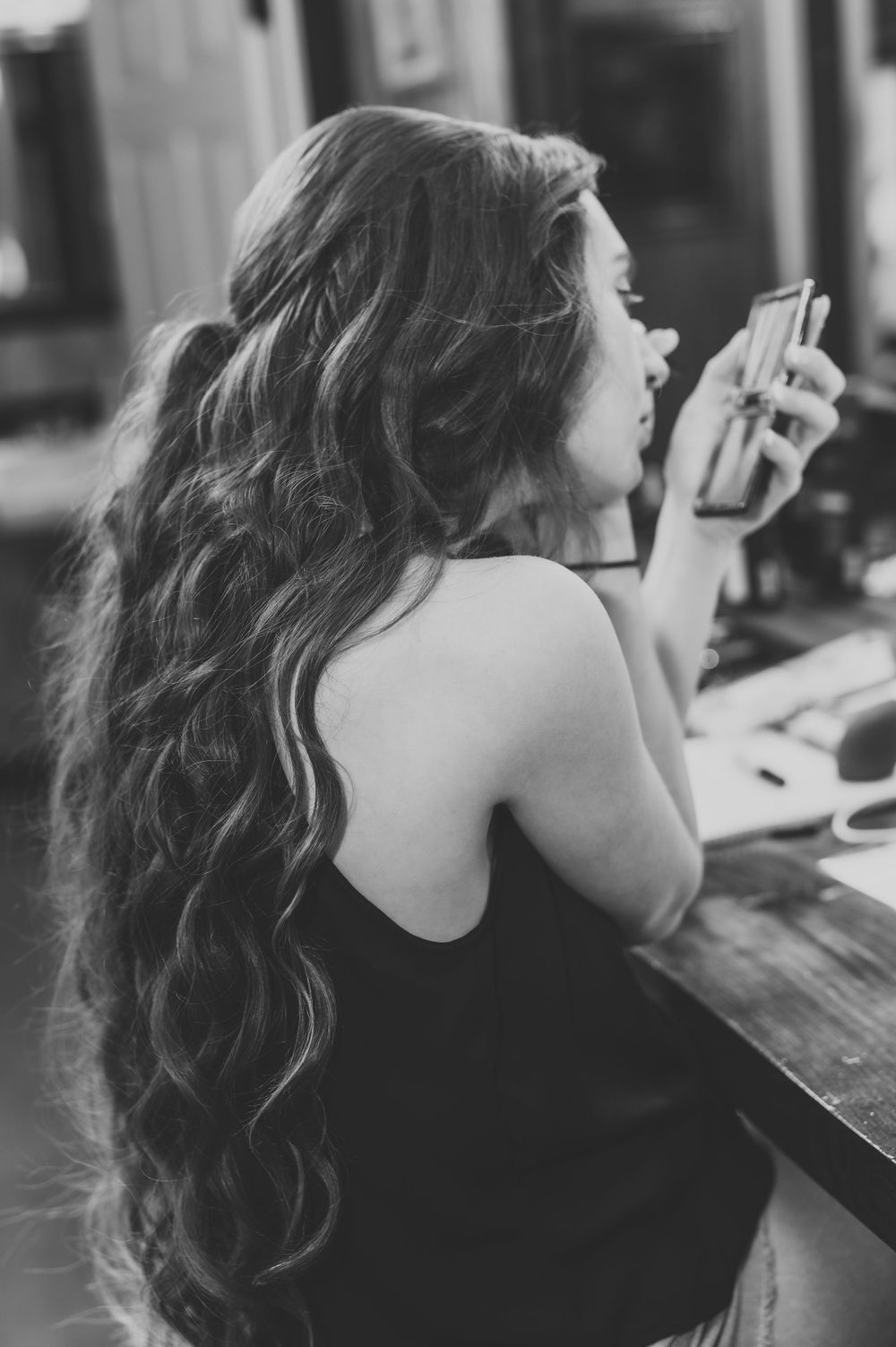Side view of long wavy hair styled for special occasion.