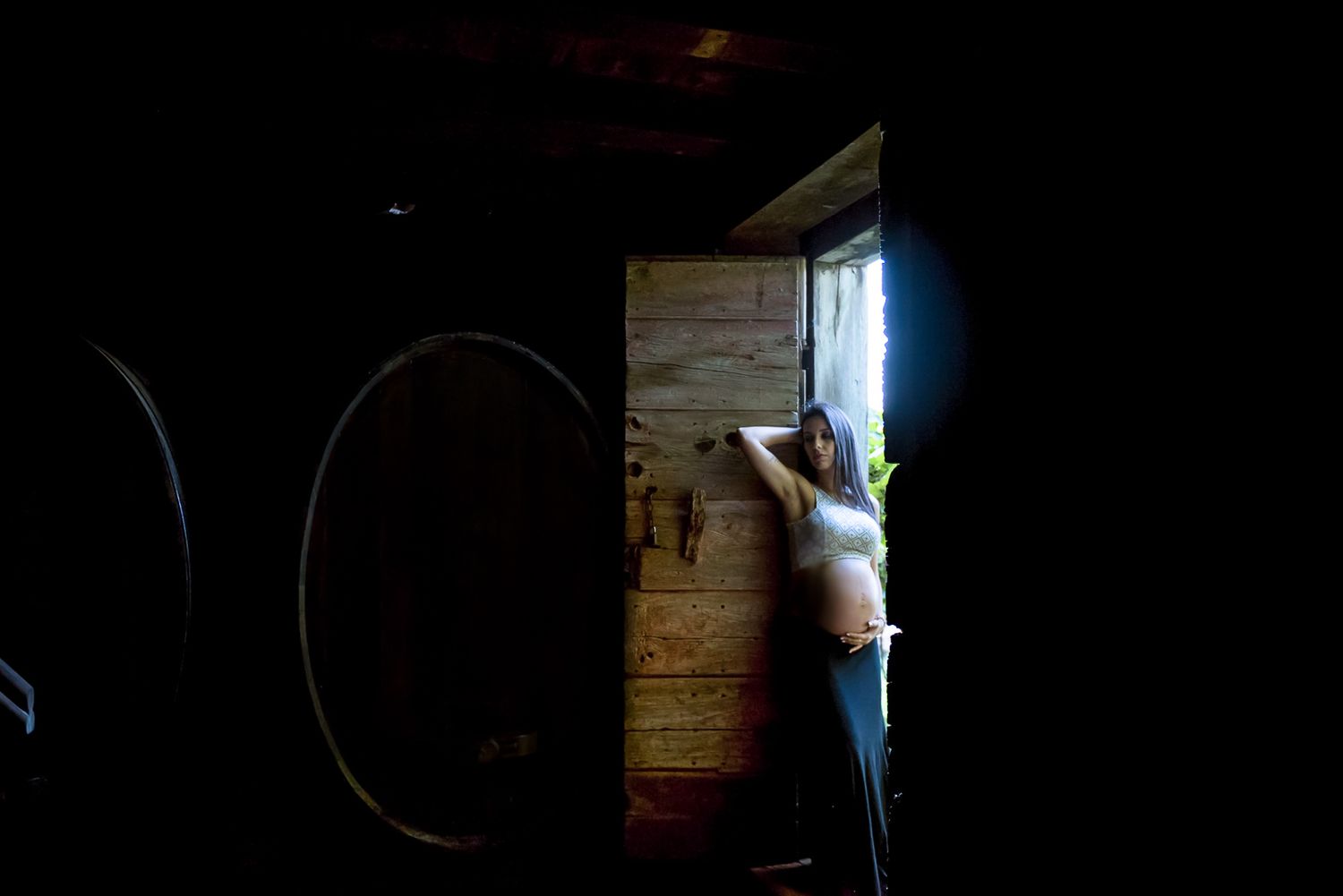 A silhouette of an expectant mother framed by a bright doorway.