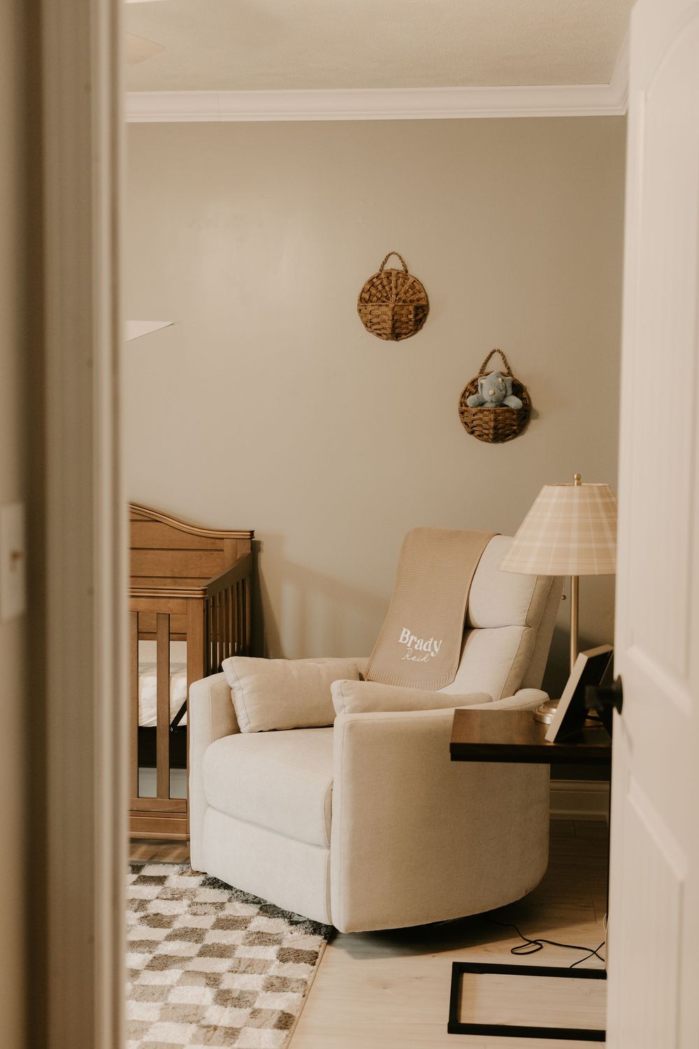 Modern living room interior with white furniture and checkered floor pattern in neutral tones.