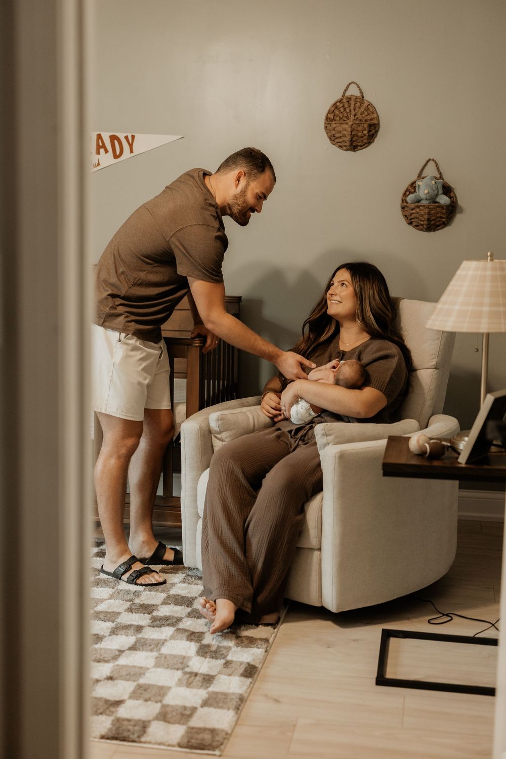 Lifestyle family photography session in a cozy nursery with modern furniture.