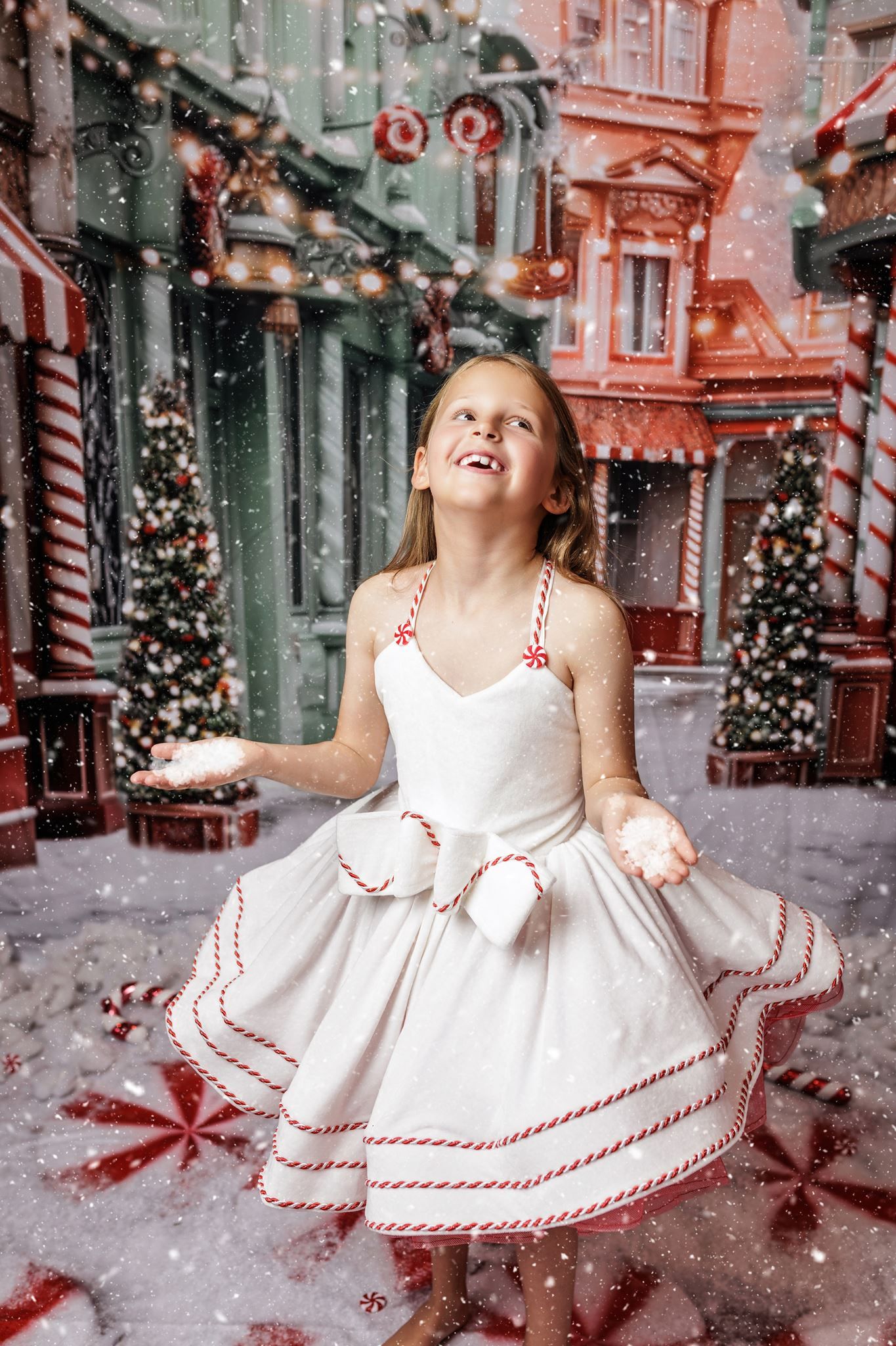 Holiday scene with excited child and festive decorations in red brick setting.
