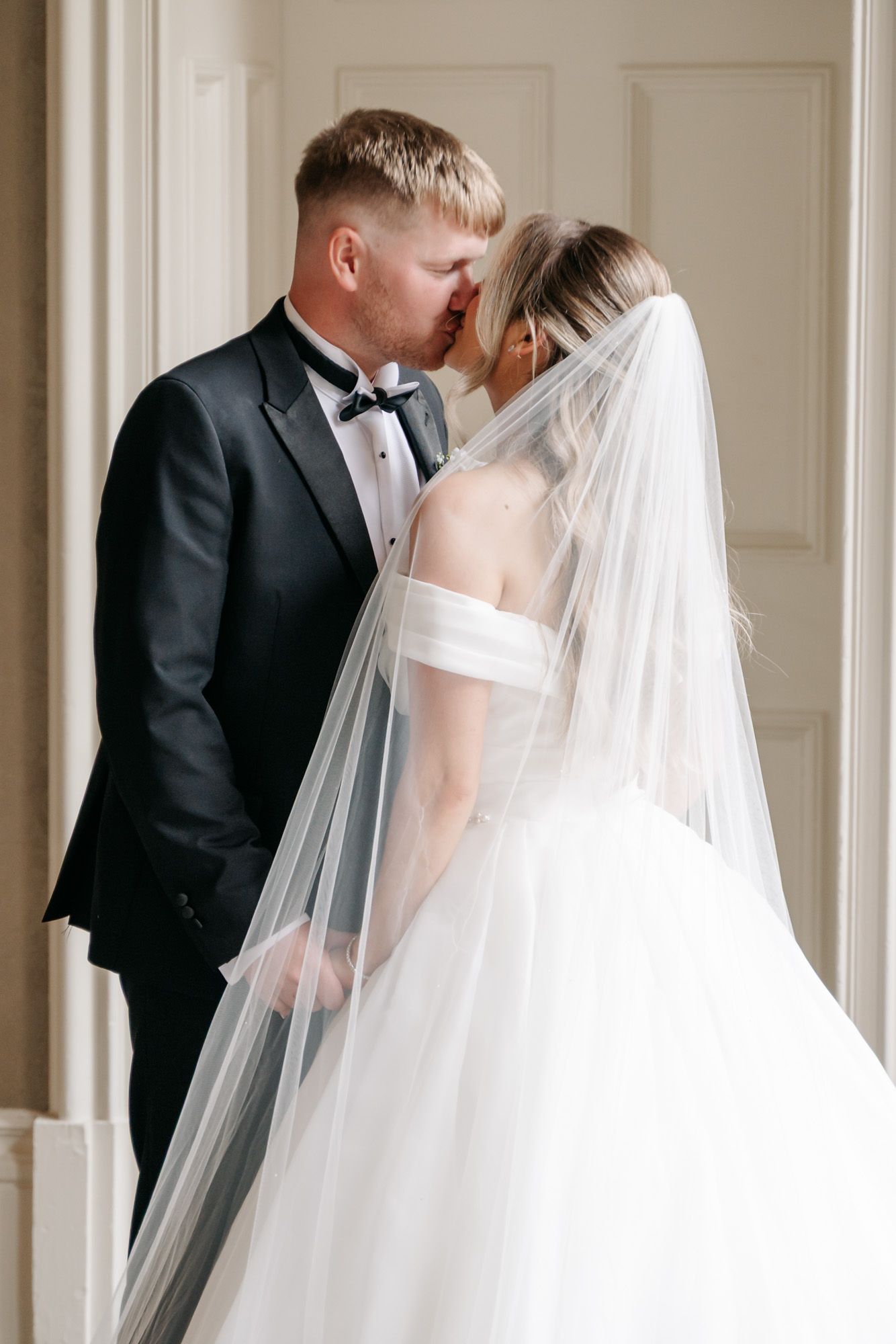 A romantic wedding sequence shows the couple kissing multiple times in an elegant white room with panelled walls.