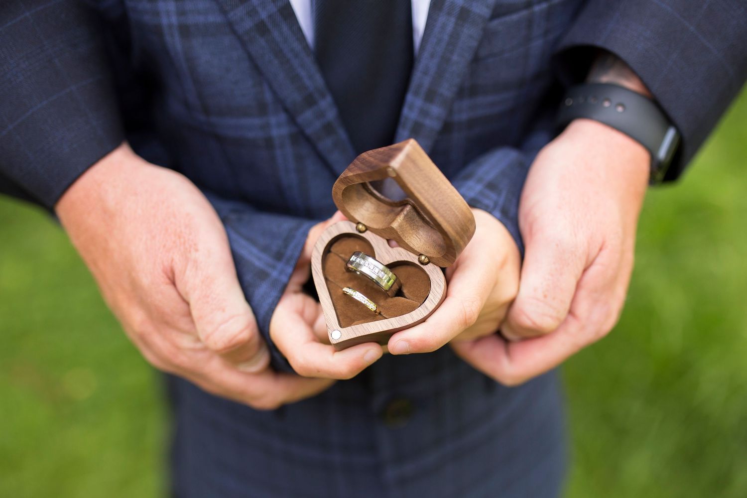 Wedding rings in hands wedding photography by Little Wonderland Photography Widnes Cheshire