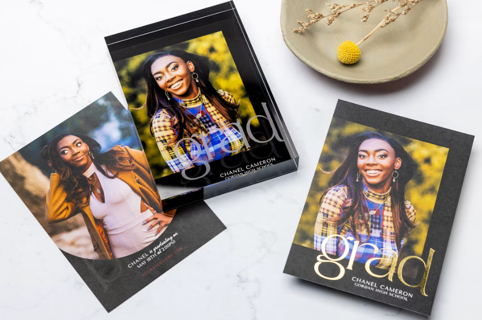 Collection of printed photographs spread out on a light colored surface.