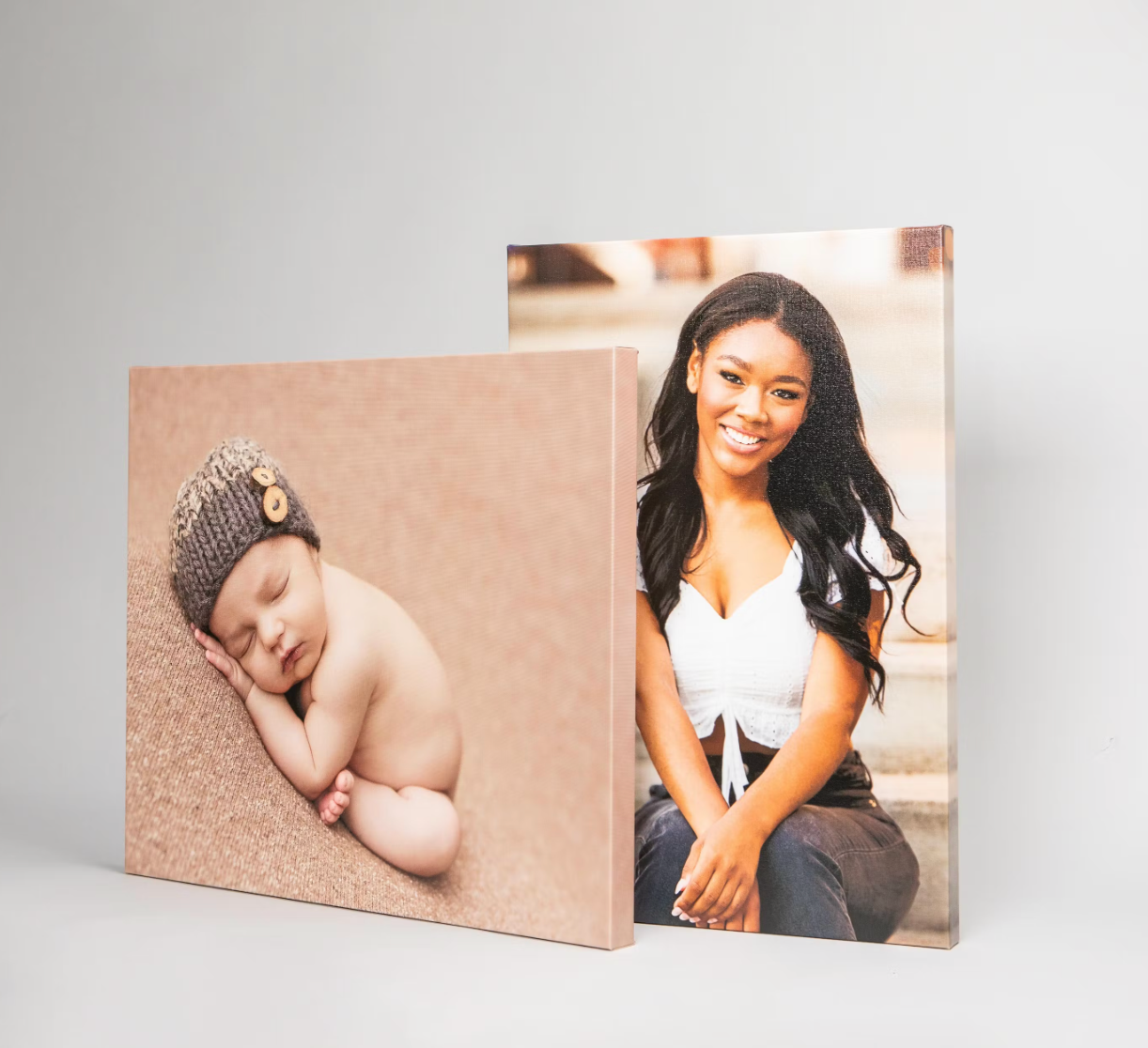 Modern photo album display with minimalist canvas prints on white background.