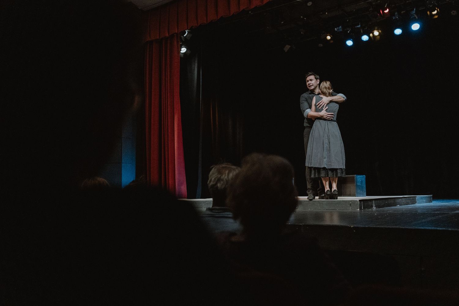 Captivating scene from a theater play featuring actors in vibrant costumes performing on stage.