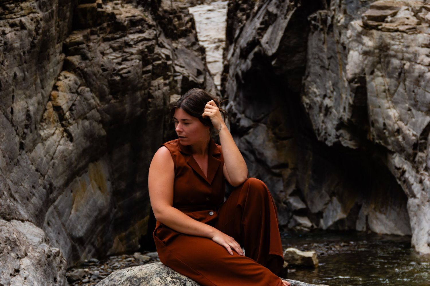 A peaceful moment captured on rocky terrain by a mountain stream.