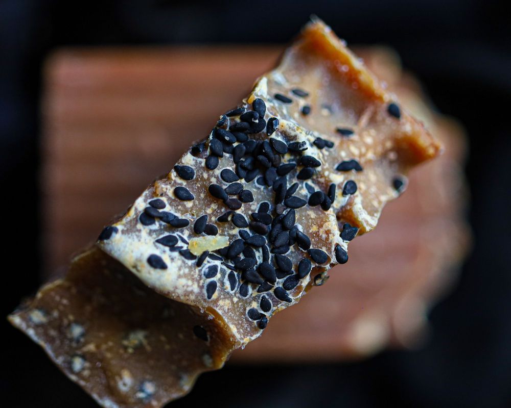 Artisanal chocolate bar with dark sea salt crystals photographed in macro.
