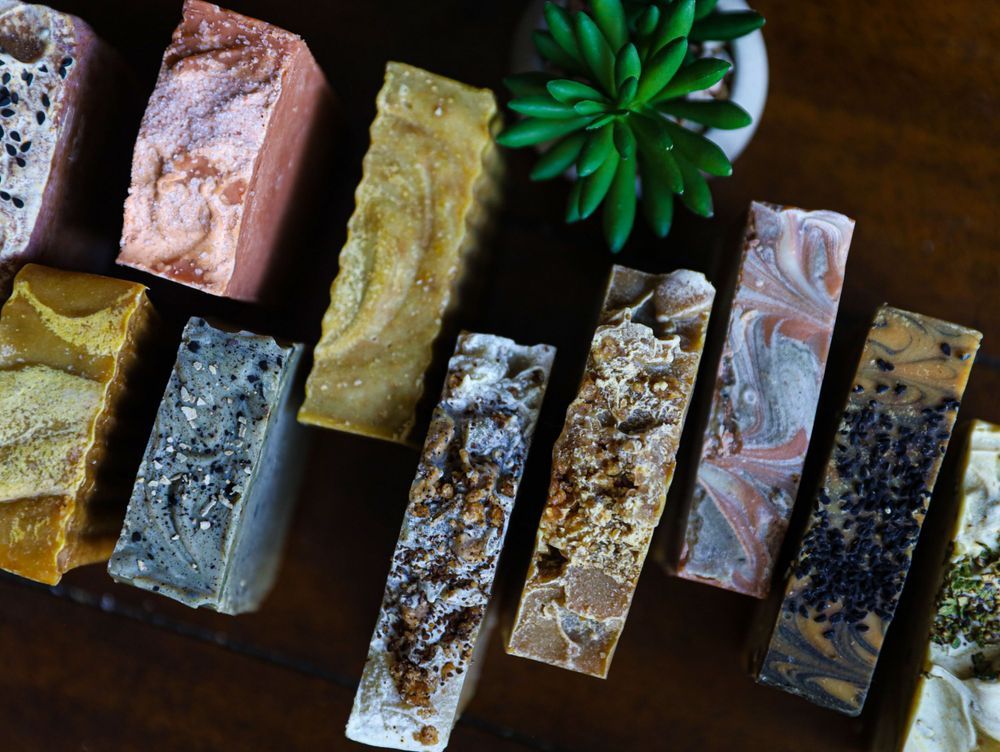 Collection of handmade artisanal soap bars in various colors and textures.