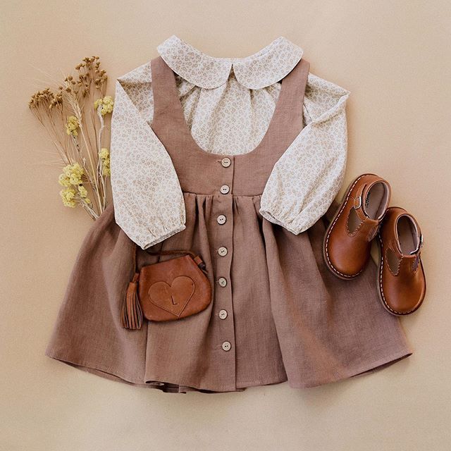 Vintage-style brown linen dress with white eyelet collar and sleeves paired with tiny brown leather shoes and purse.