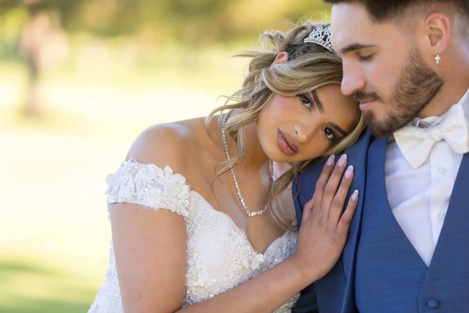 A romantic outdoor wedding portrait with soft natural lighting and elegant attire.