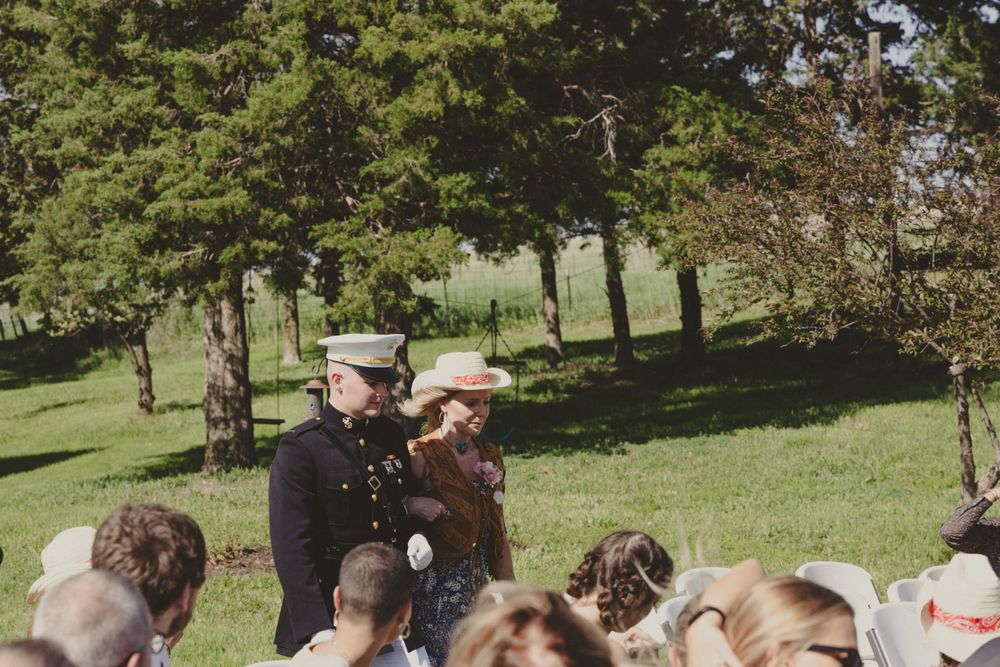 Military officer speaking to a group of children outdoors during an event.