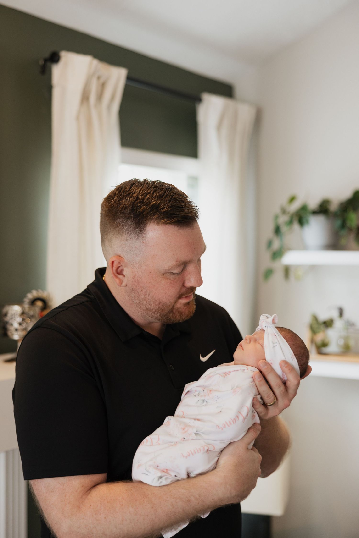 Dad and his newborn daughter photography at home in Avon, Ohio.