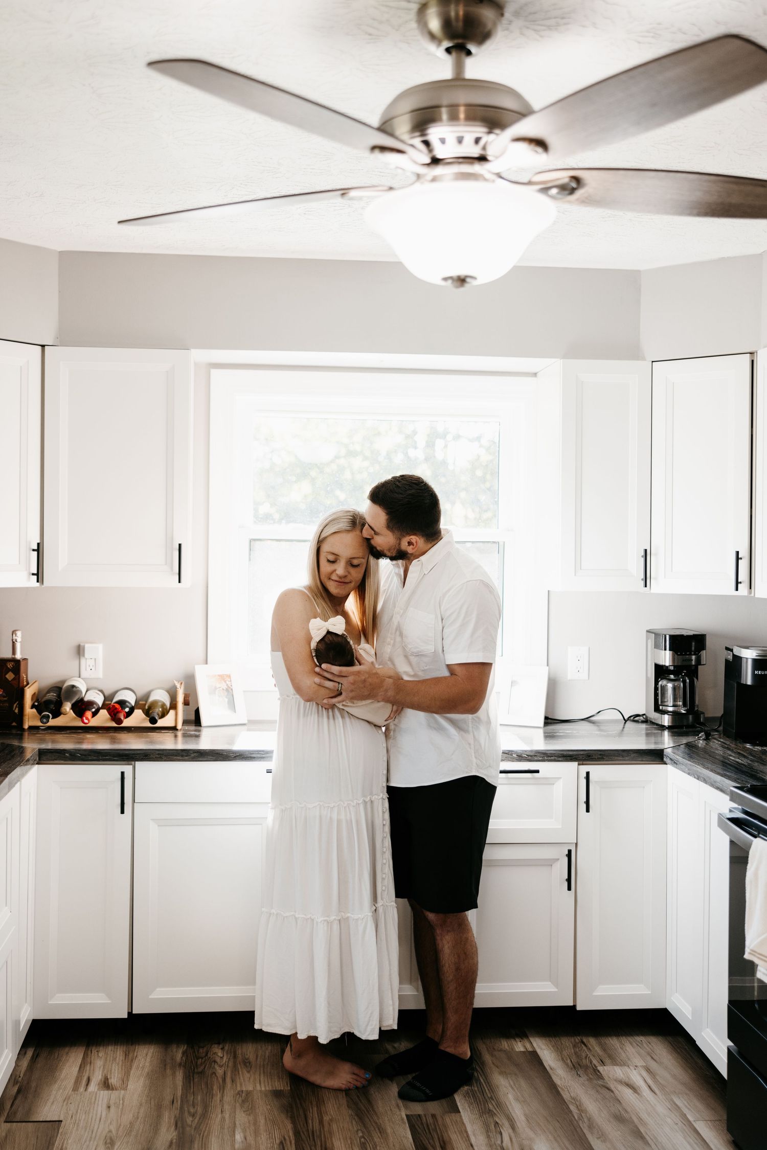 Kitchen newborn at home photography session with bright and sunny candid casual photographs in Louisville, Ohio.