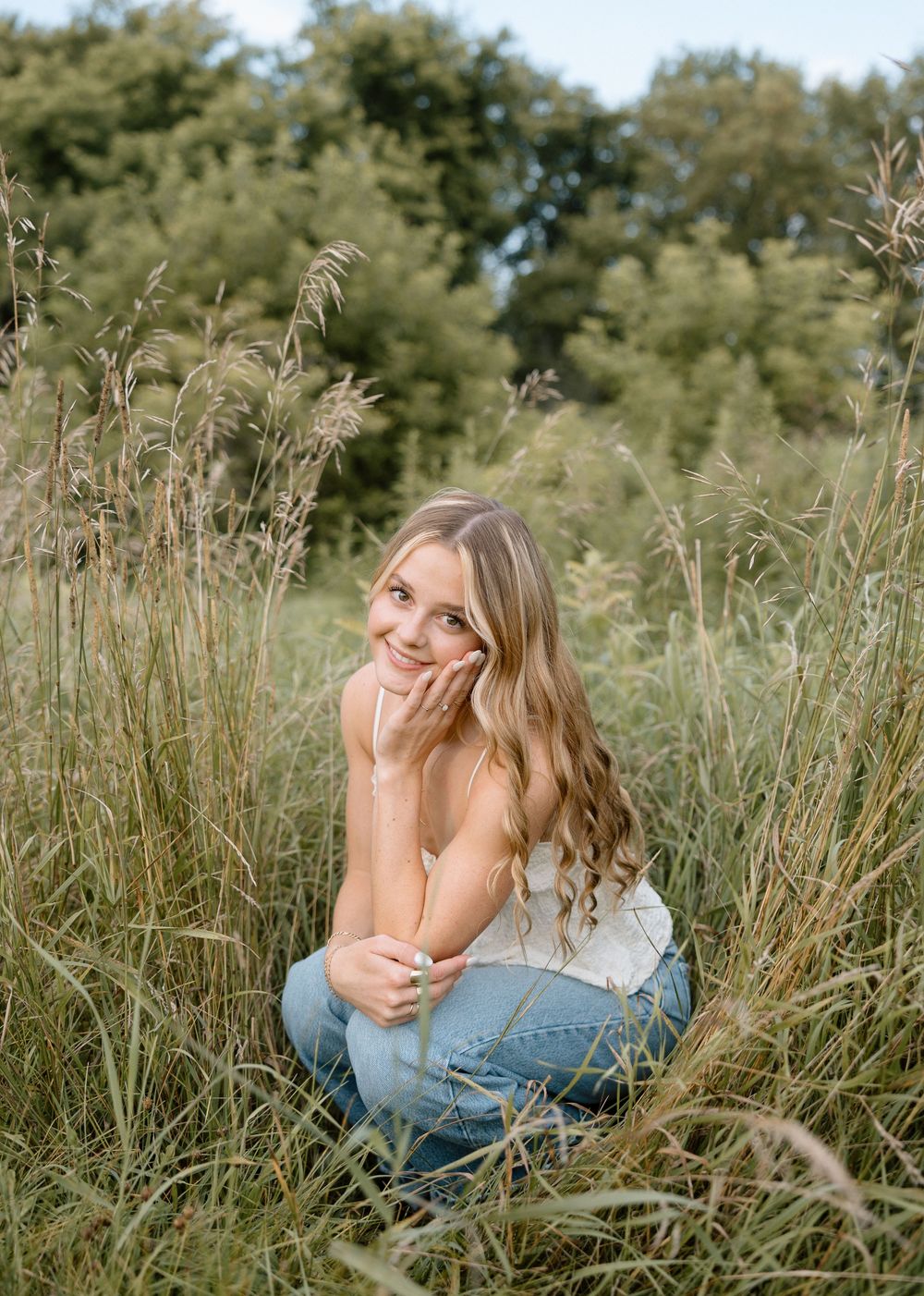 Candid moment captured lying in tall grass on a sunny day.