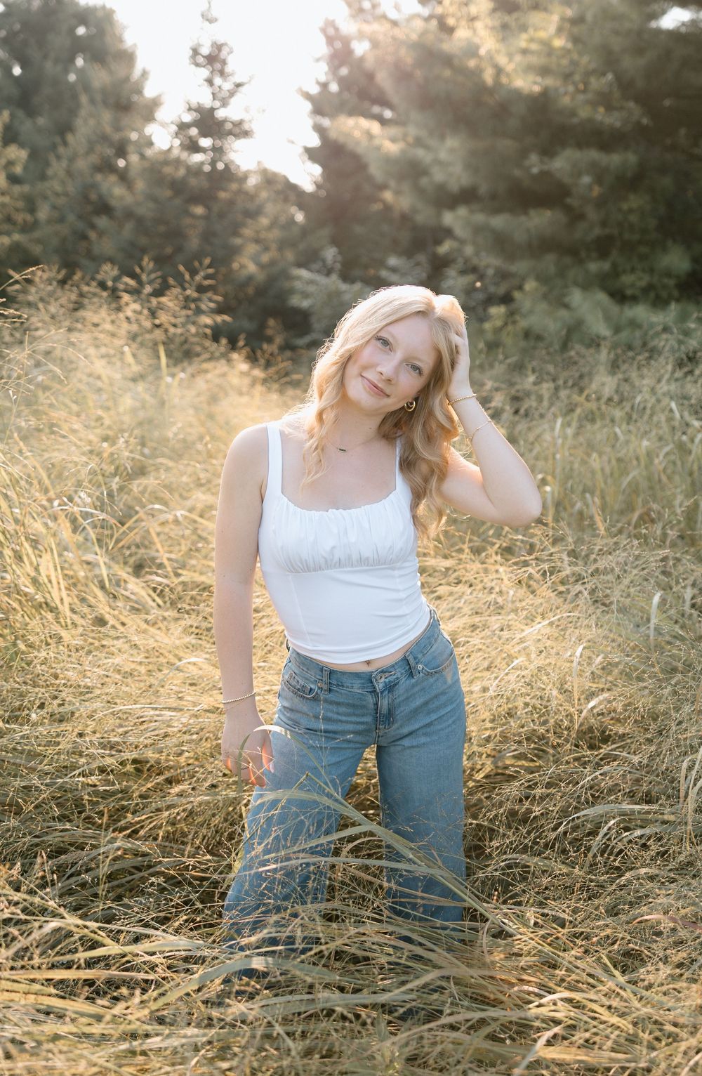 Candid poses in tall grass during a golden hour portrait session.