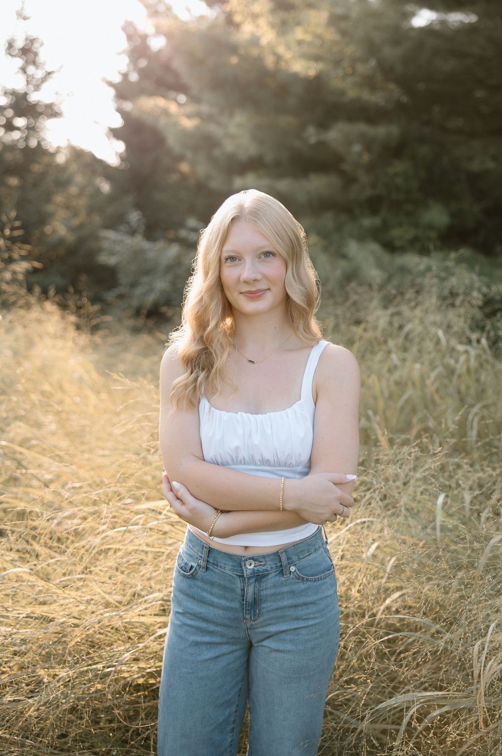 Relaxed outdoor portraits captured in warm evening light among wild grasses.