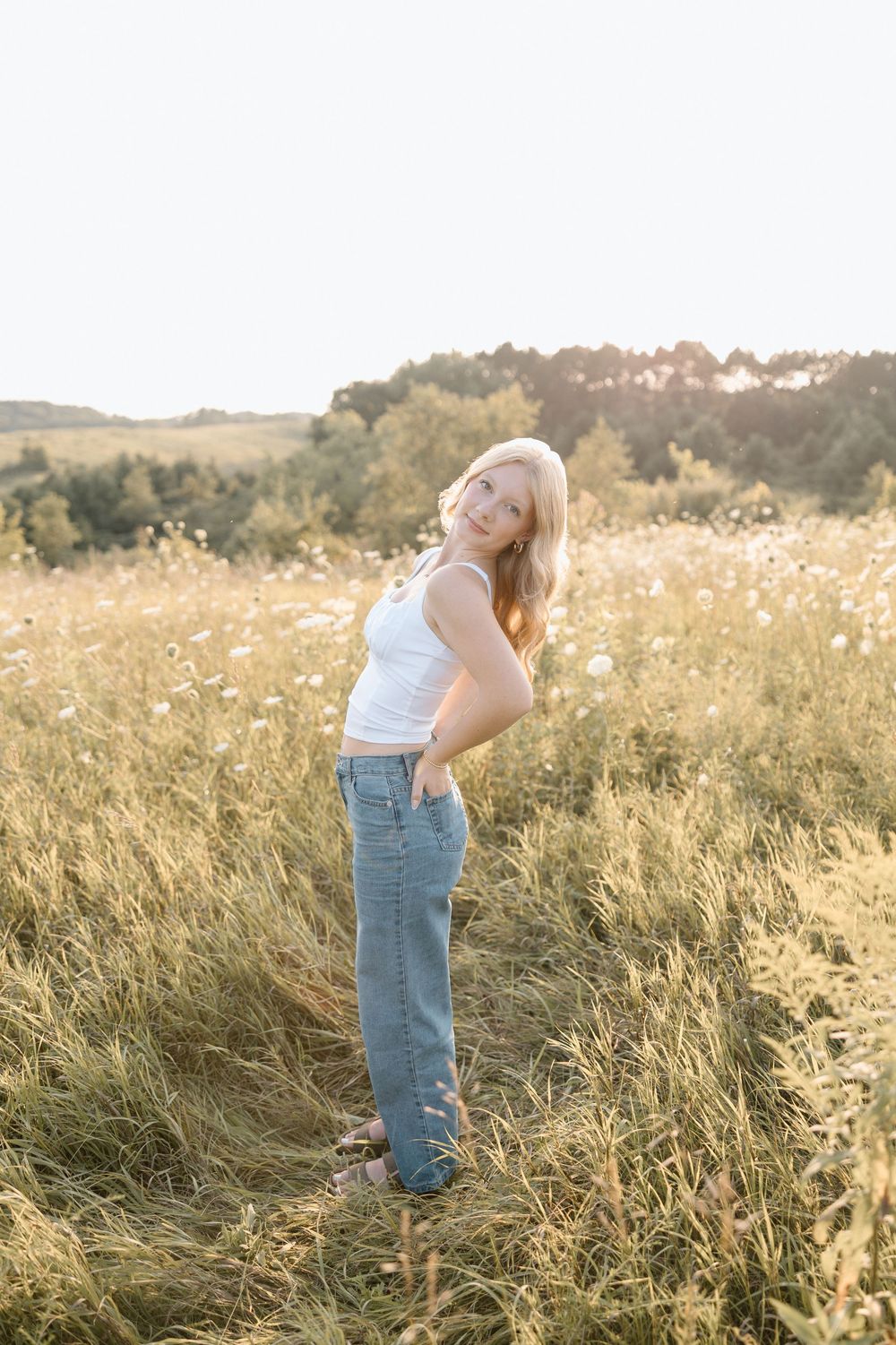 Artistic outdoor photography session in a field during golden hour.
