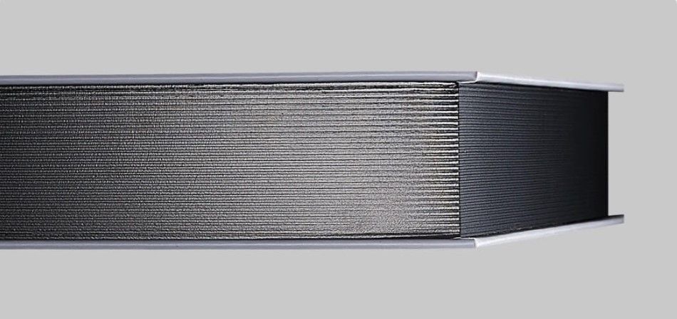A detailed photo of a flush mount album with elegant gilded edges.