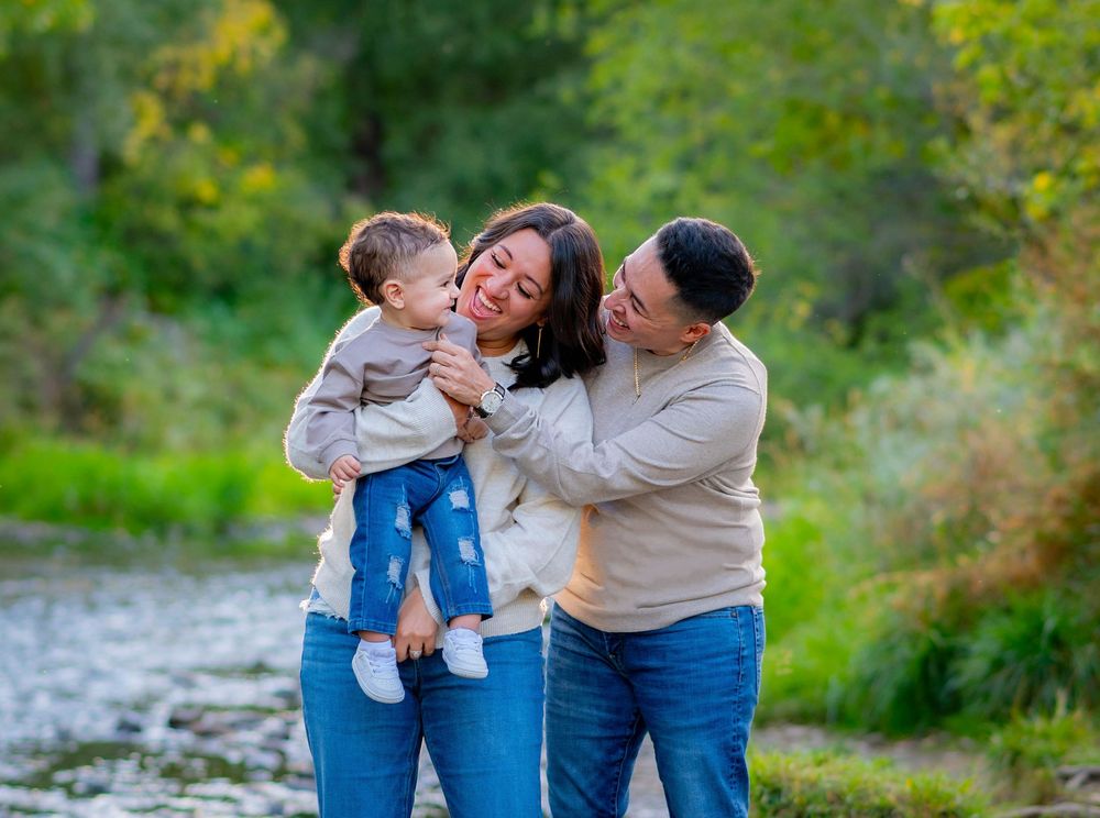 Family sharing tender moment together outdoors in natural setting.