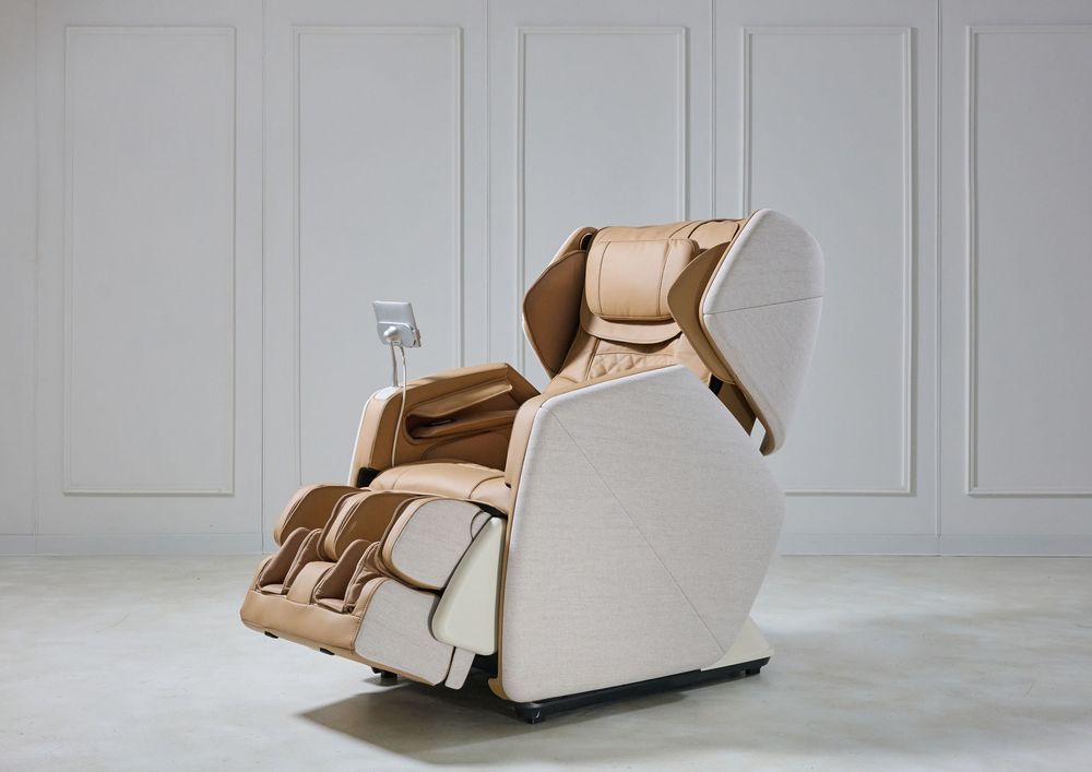 Luxury beige and tan full-body massage chair with remote control panel on white background.