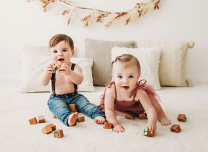 Five sequential photos of a baby crawling across a white floor reaching for chocolate chip cookies.
