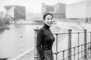 personal branding photography of female coach walking at Spree near main train station Berlin in urban surrounding.