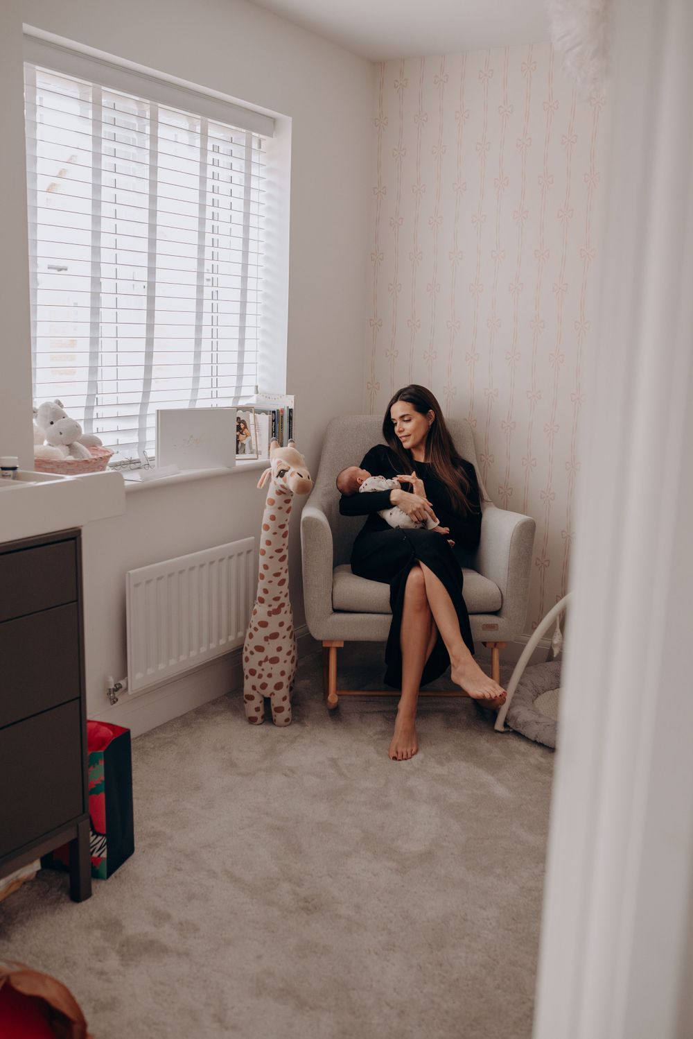 Lifestyle photography setup in bright room with white blinds and grey carpet.
