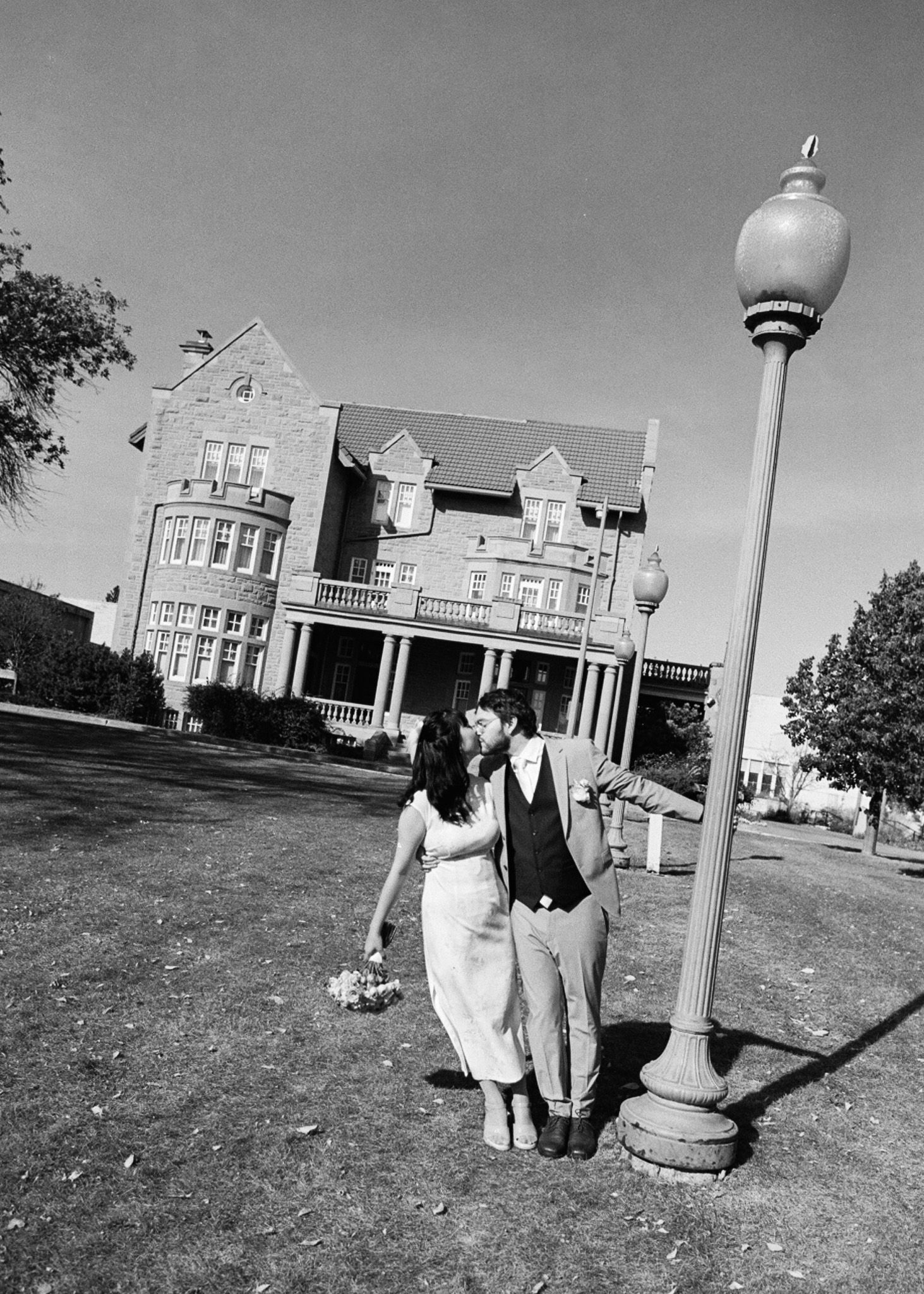 A black and white photo series showing people walking near a classic American building with white columns and architecture.