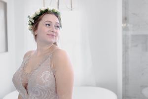 A bright ethereal bridal portrait with a white floral crown.