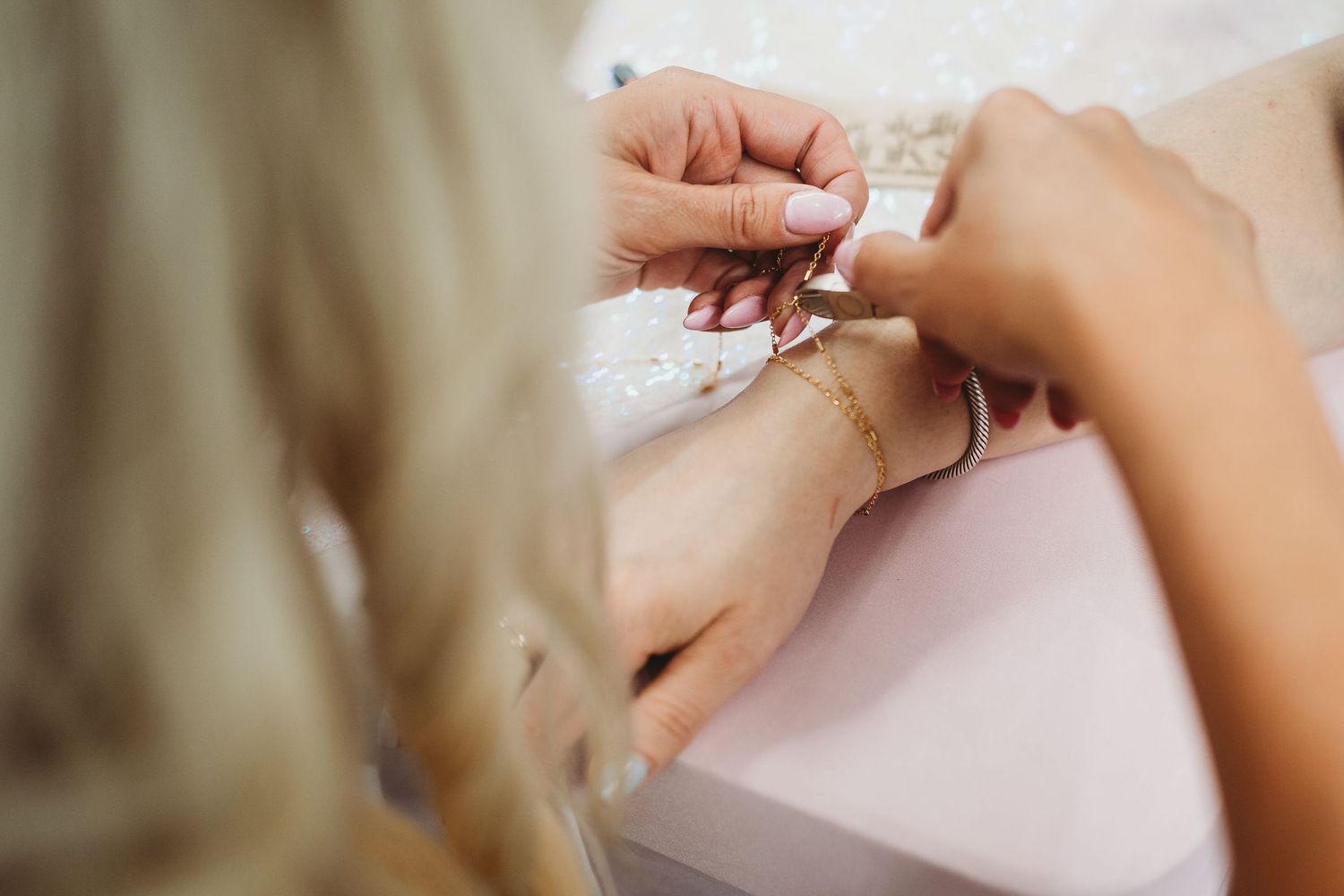 Close-up of hands applying beauty treatment in a salon setting.