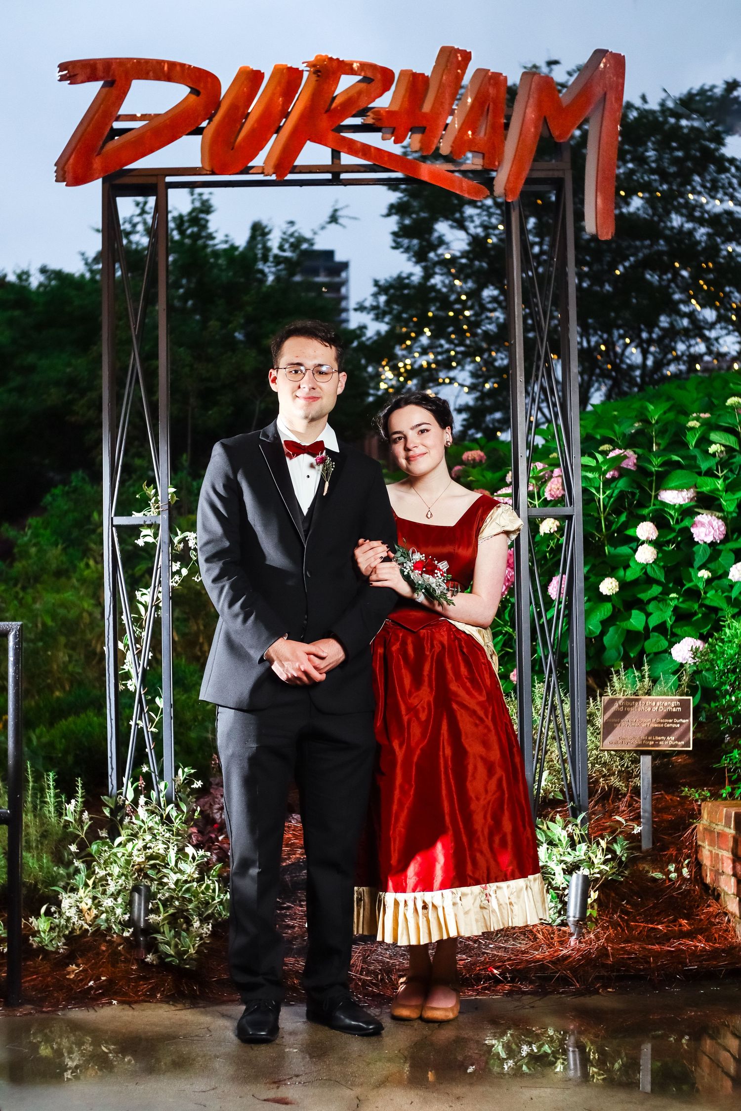 Prom couple posing in front of Durham sign