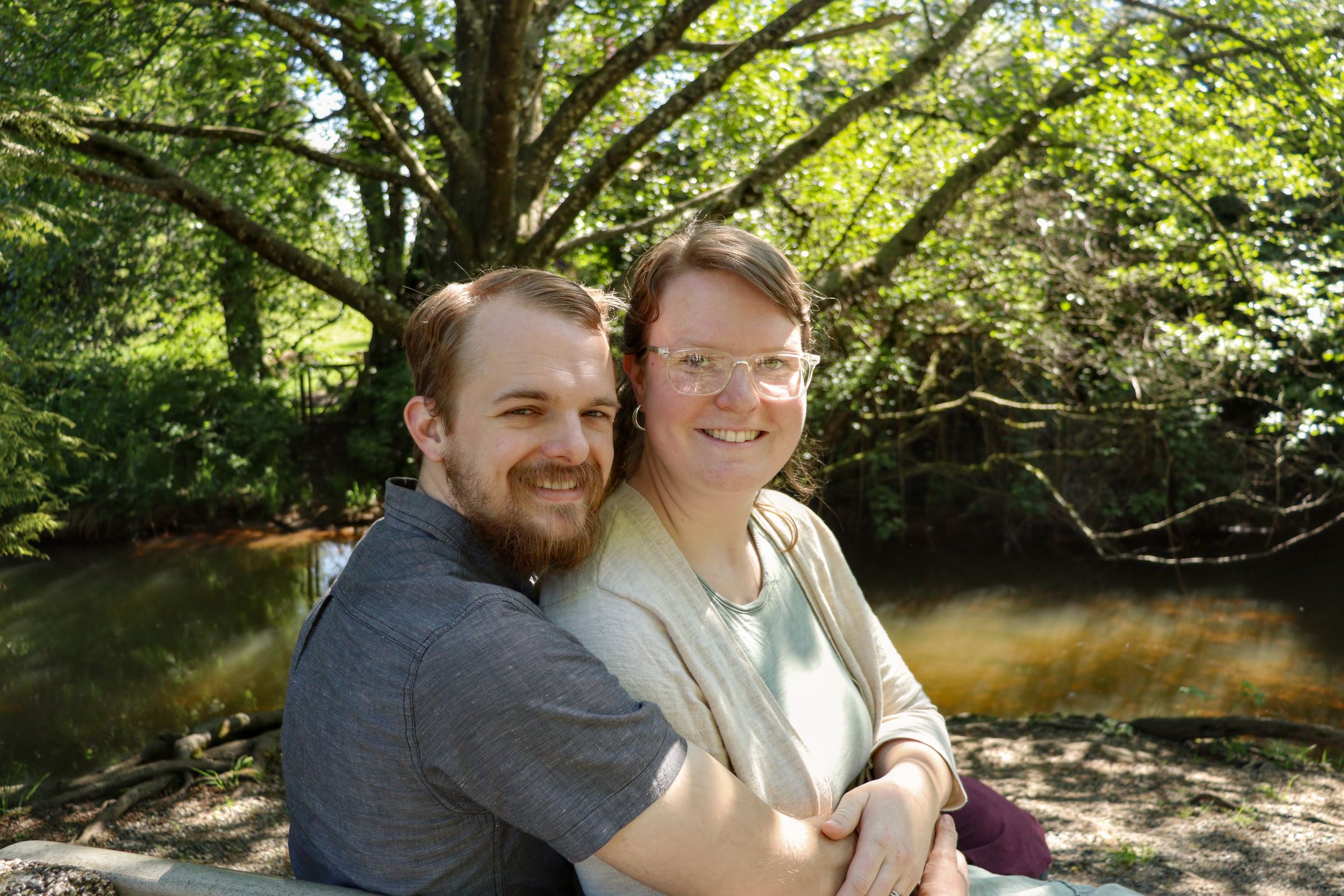 Photo of couple looking at camera and smiling.