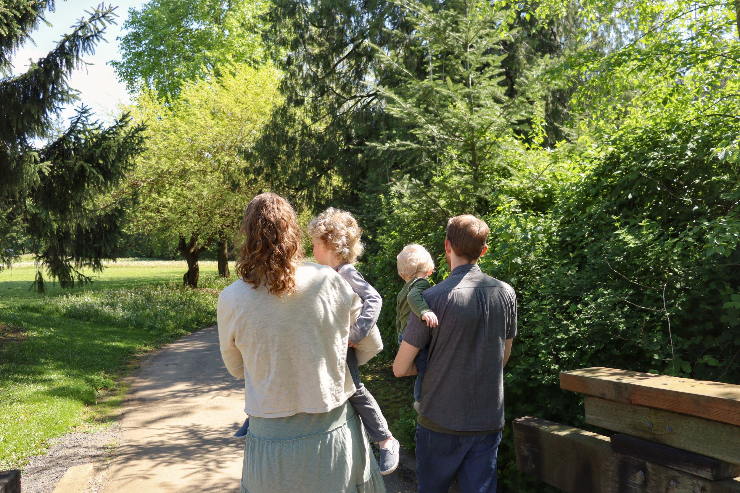 Photo of family walking away from camera.