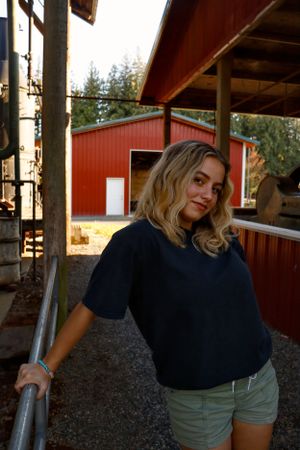 Photo of girl leaning and looking away from camera.